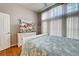 Bedroom with white dresser, TV and large window at 660 Silk Oak Dr, Venice, FL 34293