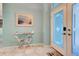 Light and airy entryway with decorative table and access to the backyard at 660 Silk Oak Dr, Venice, FL 34293