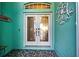 Front entry with double doors and decorative accents at 660 Silk Oak Dr, Venice, FL 34293