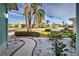 Landscaped walkway to the house with pebble stone ground covering at 660 Silk Oak Dr, Venice, FL 34293