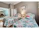 Guest bedroom with twin beds and flamingo bedding at 660 Silk Oak Dr, Venice, FL 34293
