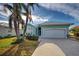 Single-story house with attached garage and palm trees at 660 Silk Oak Dr, Venice, FL 34293