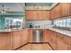 Kitchen with island, stainless steel appliances, and granite countertops at 660 Silk Oak Dr, Venice, FL 34293