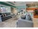 Spacious living room features comfortable seating and a large TV at 660 Silk Oak Dr, Venice, FL 34293