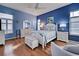 Main bedroom with white wooden furniture and blue walls at 660 Silk Oak Dr, Venice, FL 34293