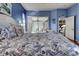 Main bedroom with a coastal-themed bedspread and sliding glass doors at 660 Silk Oak Dr, Venice, FL 34293