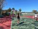 Active pickleball game in progress on the community court at 660 Silk Oak Dr, Venice, FL 34293