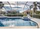 Inviting pool area with spa and screened enclosure at 660 Silk Oak Dr, Venice, FL 34293