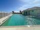 Community pool with surrounding deck and building at 660 Silk Oak Dr, Venice, FL 34293