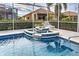 Relaxing pool and spa with tiled accents at 660 Silk Oak Dr, Venice, FL 34293