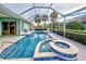 Lush pool and spa with screened enclosure and patio at 660 Silk Oak Dr, Venice, FL 34293