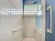 Walk-in shower with safety rails and glass enclosure at 660 Silk Oak Dr, Venice, FL 34293