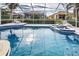 Sparkling blue swimming pool with a screened enclosure at 660 Silk Oak Dr, Venice, FL 34293