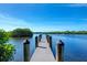 Wooden dock extending over calm blue water at 668 Alligator Dr, Venice, FL 34293