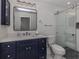 Updated bathroom with navy vanity and a walk-in shower at 703 Ironwood Dr # 114, Venice, FL 34292
