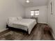Bright bedroom featuring a comfortable bed and wood-look flooring at 703 Ironwood Dr # 114, Venice, FL 34292