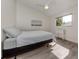 Cozy bedroom with a full-size bed and a window offering natural light at 703 Ironwood Dr # 114, Venice, FL 34292
