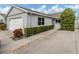 House exterior with gray siding, landscaping, and driveway at 703 Ironwood Dr # 114, Venice, FL 34292