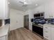 Modern kitchen with stainless steel appliances and white cabinetry at 703 Ironwood Dr # 114, Venice, FL 34292
