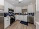 Modern kitchen with white cabinets, stainless steel appliances, and blue tile backsplash at 703 Ironwood Dr # 114, Venice, FL 34292