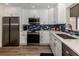Modern kitchen with white cabinets, stainless steel appliances, and blue tile backsplash at 703 Ironwood Dr # 114, Venice, FL 34292