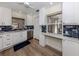Modern kitchen with white cabinets, stainless steel appliances, and blue tile backsplash at 703 Ironwood Dr # 114, Venice, FL 34292