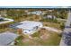 Aerial view of the home with screened-in pool and patio and large lawn at 7321 Teaberry St, Englewood, FL 34224