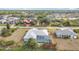An aerial view of the property featuring a screened-in pool and mature landscaping in a quiet neighborhood at 7321 Teaberry St, Englewood, FL 34224