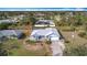 Aerial view of the single Gathering home featuring an enclosed pool, large backyard, and attached garage at 7321 Teaberry St, Englewood, FL 34224