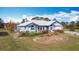 Aerial view of single story home with attached garage and screened pool at 7321 Teaberry St, Englewood, FL 34224