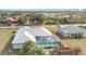 Aerial view of the property featuring a screened-in pool and mature landscaping in a quiet neighborhood at 7321 Teaberry St, Englewood, FL 34224