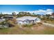 Aerial view of the home with attached garage and screened pool at 7321 Teaberry St, Englewood, FL 34224