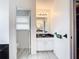 Bathroom featuring a white vanity with a black countertop, sink, and tile flooring at 7321 Teaberry St, Englewood, FL 34224