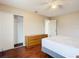 A bedroom with wood floors, a ceiling fan, closet space, and neutral paint at 7321 Teaberry St, Englewood, FL 34224