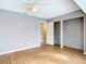 Bedroom with hardwood floors, a ceiling fan, a closet, and gray walls at 7321 Teaberry St, Englewood, FL 34224