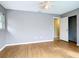 Bedroom with hardwood floors, a ceiling fan, and gray walls at 7321 Teaberry St, Englewood, FL 34224