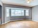 Bedroom with hardwood floors, bay windows, and a ceiling fan at 7321 Teaberry St, Englewood, FL 34224