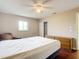 Comfortable bedroom featuring wood flooring, a ceiling fan, and a window for natural light at 7321 Teaberry St, Englewood, FL 34224