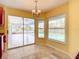 Dining area with large sliding glass doors offering natural light and stunning pool views for enjoyable dining experiences at 7321 Teaberry St, Englewood, FL 34224