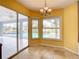 Bright dining area with large sliding glass doors, natural lighting, and views of the sparkling pool and outdoor space at 7321 Teaberry St, Englewood, FL 34224