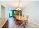 Traditional dining room featuring tile floors, an elegant chandelier, and a large wooden table at 7321 Teaberry St, Englewood, FL 34224