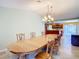 Well-lit dining room showcasing a spacious wooden table set near an open kitchen concept at 7321 Teaberry St, Englewood, FL 34224