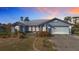 Charming single-story home featuring an attached two-car garage and a well-maintained, landscaped front yard at 7321 Teaberry St, Englewood, FL 34224
