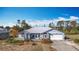 Exterior home view with attached garage and arched windows at 7321 Teaberry St, Englewood, FL 34224