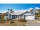 Well-maintained single-story home with an attached two-car garage and arched windows at 7321 Teaberry St, Englewood, FL 34224