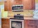 Well-equipped kitchen featuring stainless steel appliances, including a microwave and range stove for culinary enthusiasts at 7321 Teaberry St, Englewood, FL 34224