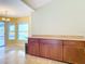 Kitchen area with wooden cabinets and natural light, blending functionality with a touch of contemporary design at 7321 Teaberry St, Englewood, FL 34224