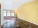 Spacious living room featuring tile floors, arched windows, and vaulted ceilings creating a bright and airy atmosphere at 7321 Teaberry St, Englewood, FL 34224