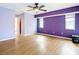 Spacious main bedroom featuring wood floors, modern ceiling fan, and large windows at 7321 Teaberry St, Englewood, FL 34224