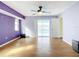 Open main bedroom with hardwood floors, ceiling fan, sliding glass doors, and a bright atmosphere at 7321 Teaberry St, Englewood, FL 34224